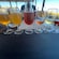 6 glasses filled with a variety of beers and wines